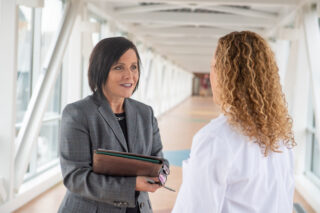 An MSN nurse speaks with a hospital administrator